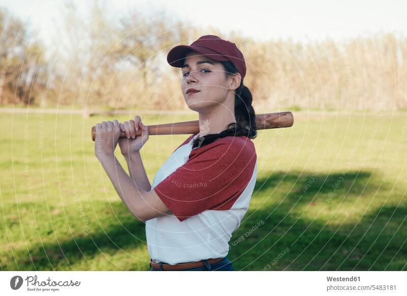 Portrait of young woman with baseball bat in park Bat Sports Bat females women sport sports Adults grown-ups grownups adult people persons human being humans