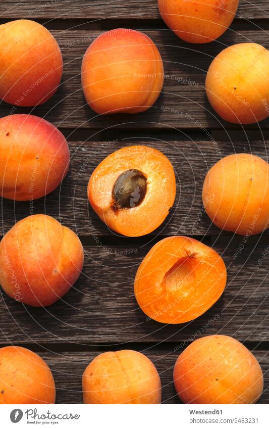 Sliced and whole organic apricots on wood food and drink Nutrition Alimentation Food and Drinks vitamines half halves halved sliced orange
