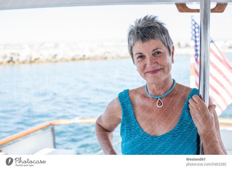 Smiling mature woman on a boat trip smiling smile boats females women Adults grown-ups grownups adult people persons human being humans human beings boating