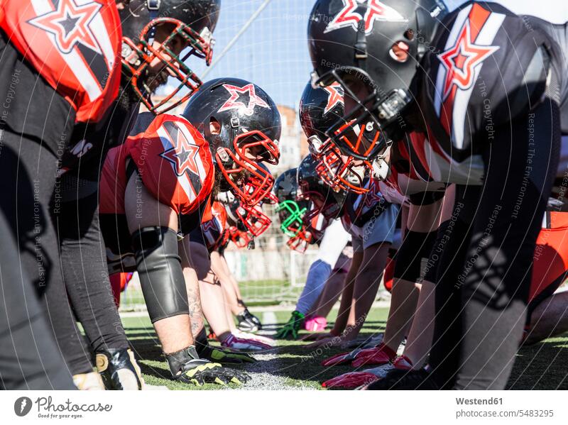 American football players on the line of scrimmage during a match helmet helmets Protective Headwear Football sport sports sports field sports fields training