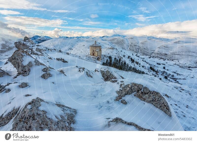 Italy, Abruzzo, Gran Sasso e Monti della Laga National Park, The small church of Santa Maria della Pieta in Rocca Calascio at sunset in winter