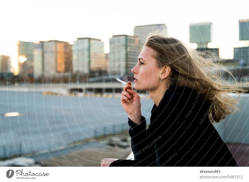 Spain, Barcelona, pensive young woman smoking cigarette cigarettes females women smoke tobacco product Tobacco Products Adults grown-ups grownups adult people
