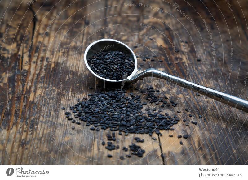Mass of organic black sesame on dark wood grains sesame seeds organic edibles scattered Black sesame aroma flavour aromatic rustic nobody food and drink