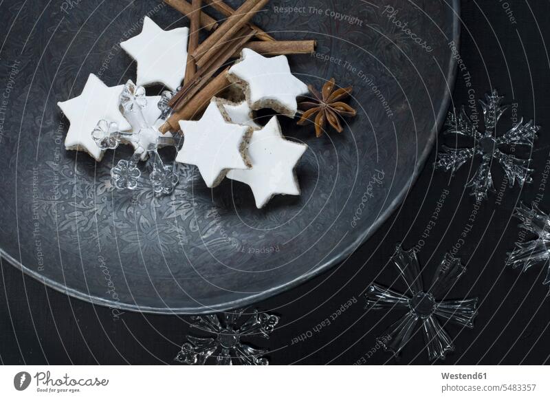 Cinnamon stars, cinnamon sticks, star anise and decoration on metal plate Bowl Bowls overhead view from above top view Overhead Overhead Shot View From Above