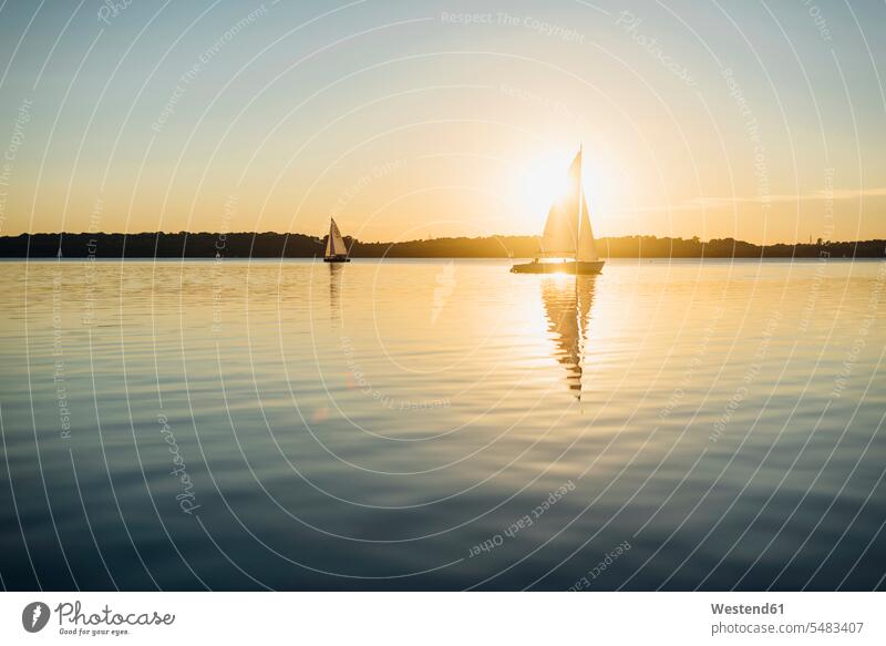 Sailing boat on Lake Cospuden at sunset copy space beauty of nature beauty in nature nobody Travel water reflection water reflections sunsets sundown Backlit