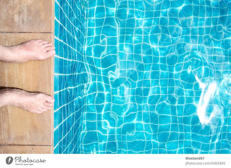 Feet of a man at pool edge caucasian caucasian ethnicity caucasian appearance european Courage bravery water reflections fear anxiety light blue standing
