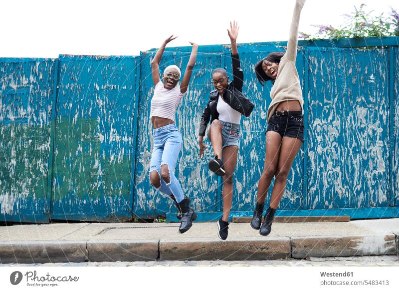 Three friends jumping in the air female friends jump in the air Leaping mate friendship jumps excitement enthusiastic enthusiasm excited Ardour Ardor woman