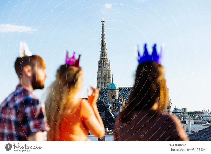 Austria, Vienna, Young people having a party on rooftop terrace friendship fancy chic entertainment St. Stephen's Cathedral Stephansdom St Stephan's Cathedral