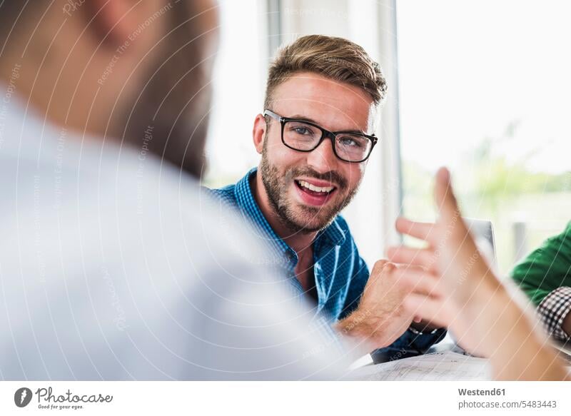 Confident young professional in a meeting Business Meeting business conference smiling smile man men males Meetings Adults grown-ups grownups adult people