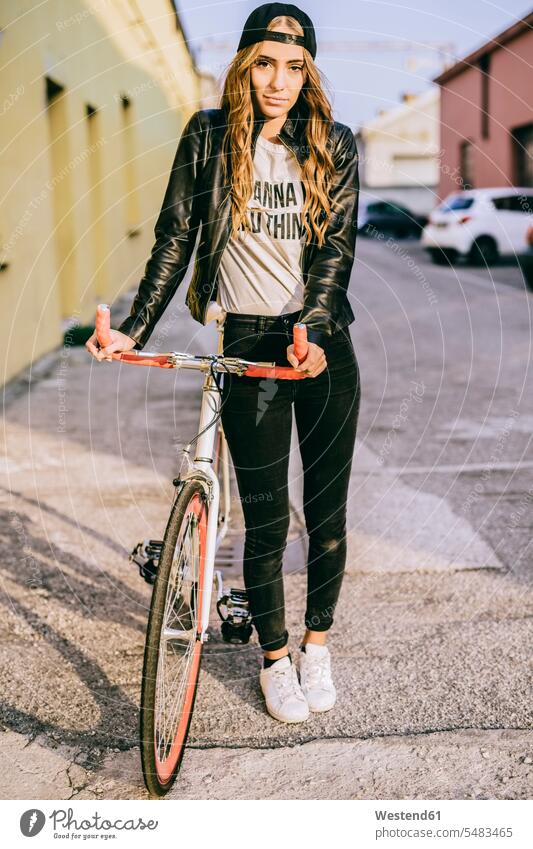 Portrait of fashionable young woman with bicycle bikes bicycles portrait portraits females women Adults grown-ups grownups adult people persons human being