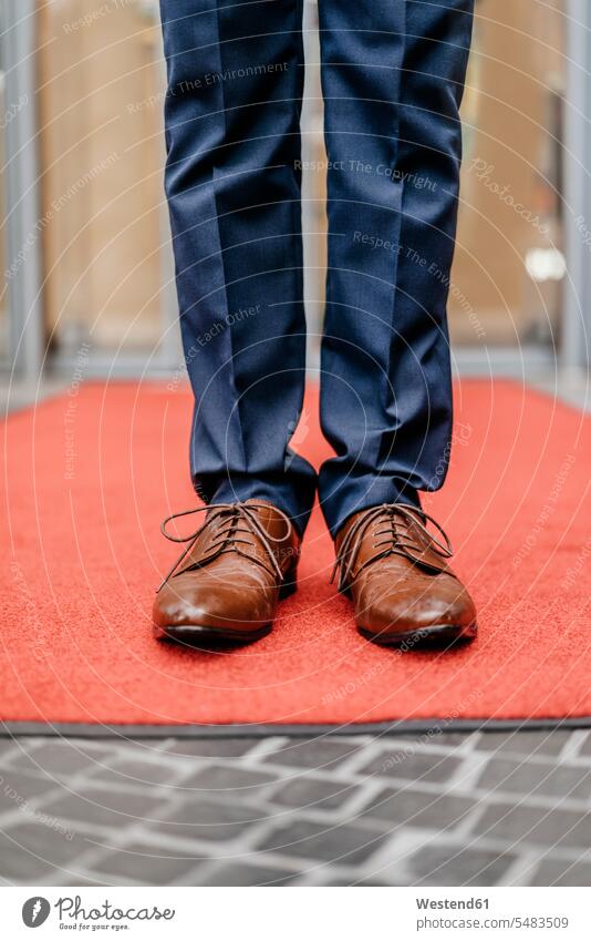 Businessman standing on red carpet, partial view Business man Businessmen Business men business people businesspeople business world business life males