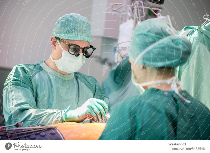 Heart surgeon during a heart operation surgery surgeries operating Surgical cardiac operation healthcare and medicine medical Healthcare And Medicines