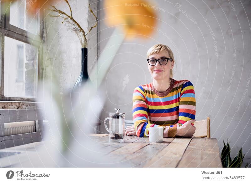 Portrait of smiling woman with cup of coffee in a loft freelancer freelancing females women lofts Adults grown-ups grownups adult people persons human being