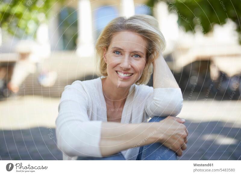 Portrait of smiling blond woman with hand in her hair females women portrait portraits Adults grown-ups grownups adult people persons human being humans