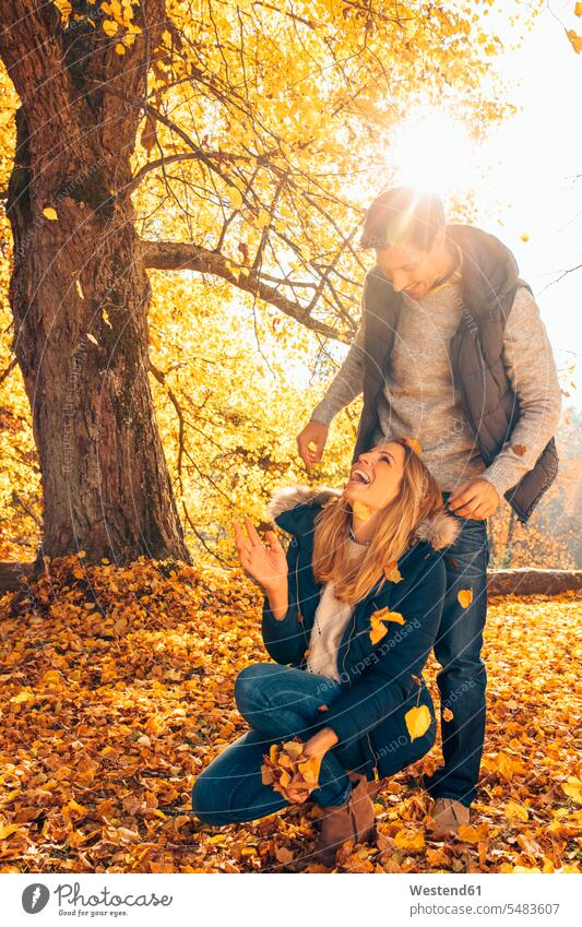 Happy couple having fun in autumn in a forest excursion Getaway Trip Tours Trips mischief rampaging rampage autumn landscape autumnal landscape