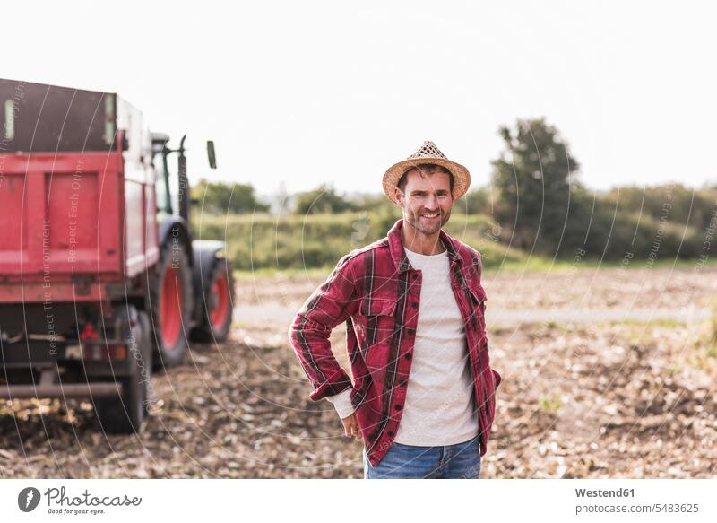Portrait of confident farmer on field agriculturists farmers Field Fields farmland man men males smiling smile agriculture Adults grown-ups grownups adult