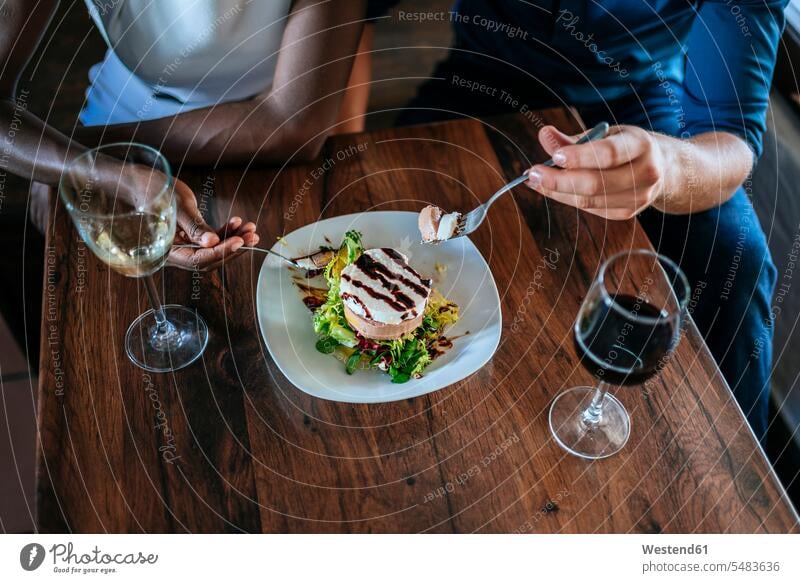 Close-up of a couple eating together in restaurant twosomes partnership couples restaurants Wine people persons human being humans human beings Alcohol