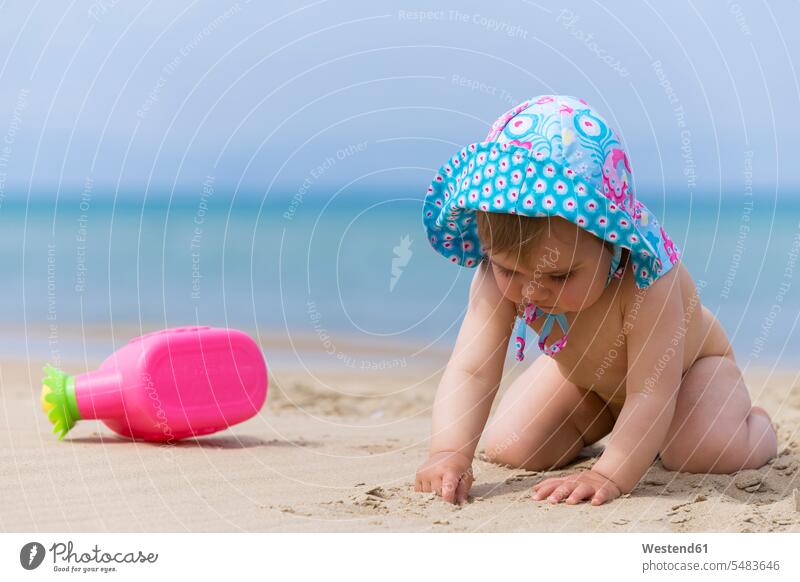 Little baby girl wearing summer hat playing on the beach Landscape - Nature Landscape - Scenery landscapes scenery terrain coast area coastline Seacoast seaside