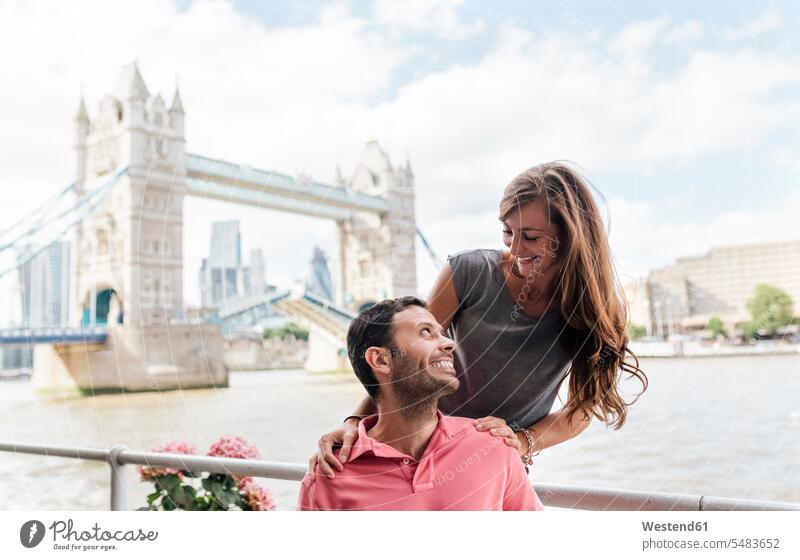 UK, London, happy couple with the Tower Bridge in the background happiness twosomes partnership couples England United Kingdom Great Britain people persons
