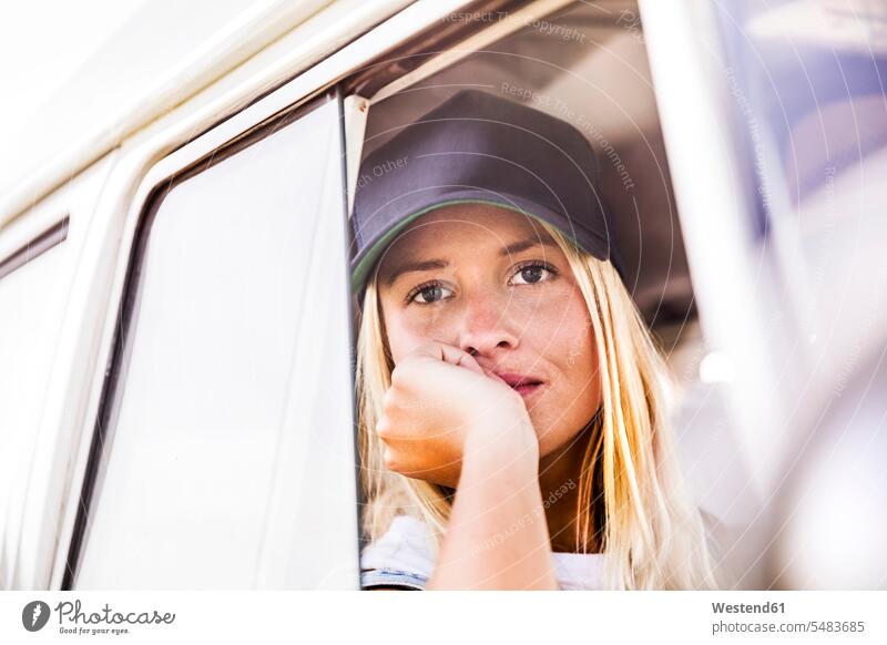 Young woman looking out of window of a van portrait portraits females women Adults grown-ups grownups adult people persons human being humans human beings
