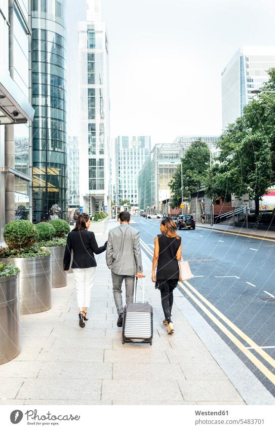 Businesspeople walking through the city businesswoman businesswomen business woman business women Businessman Business man Businessmen Business men going