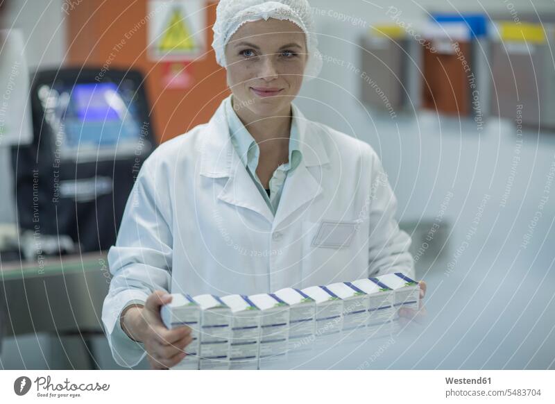 Lab worker in pharmaceutical plant packaging medicine medication drugs Medicines medicament working At Work laboratory technician woman females women