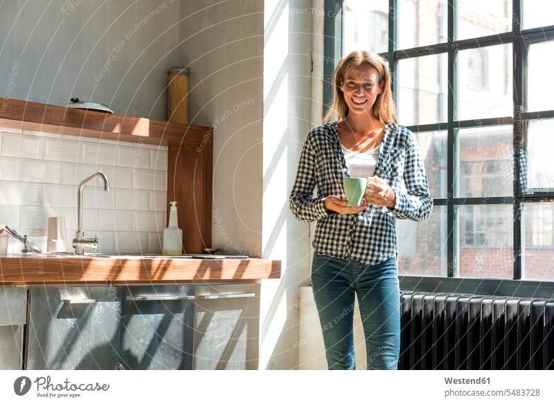 Young woman entrepreneur standing in company kitchen, drinking coffee young entrepreneur young entrepreneurs female Coffee office offices office room