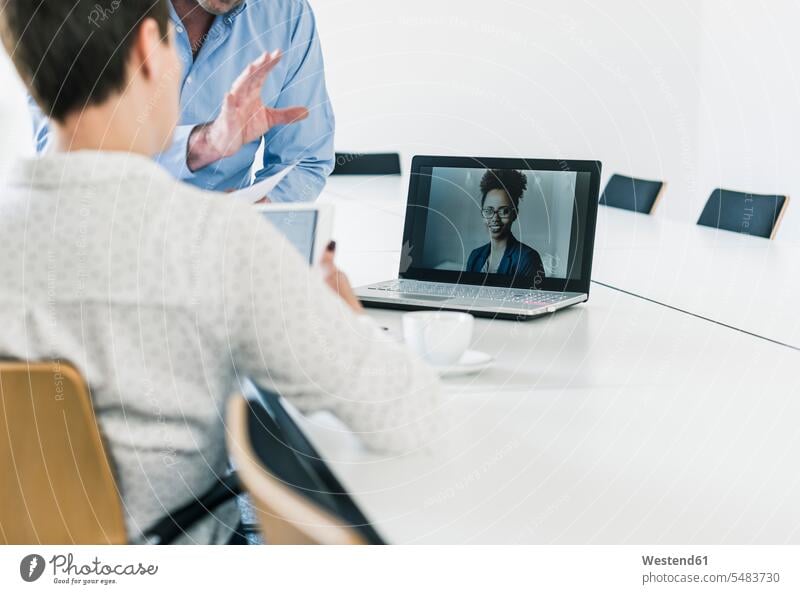 Business people having a video conference in office business people businesspeople Video Conference video conferencing laptop Laptop Computers laptops notebook
