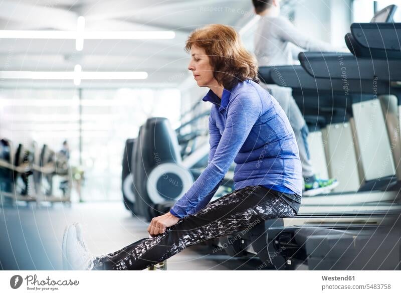 Senior woman resting after working out in gym gyms Health Club fitness sport sports break Vitality Verve vigour vigorous leisure free time leisure time sitting