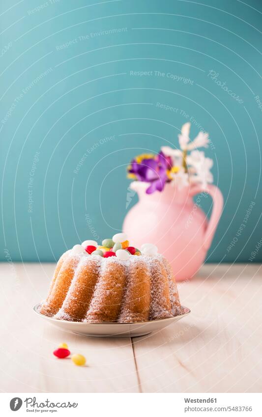 Ring cake with Easter eggs and bunch of flowers in the background food and drink Nutrition Alimentation Food and Drinks flower head flower heads flower vase