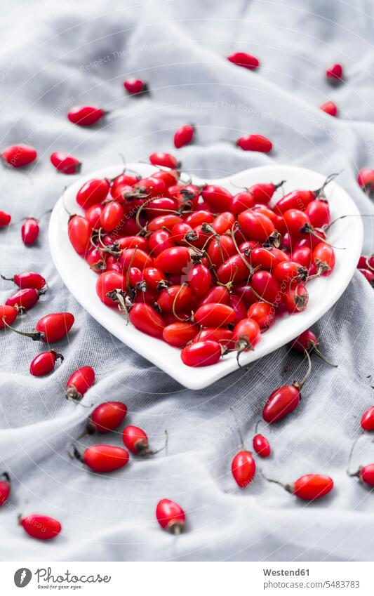 Heart-shaped bowl of goji berries on cloth food and drink Nutrition Alimentation Food and Drinks Lycium barbarum large group of objects many objects heart