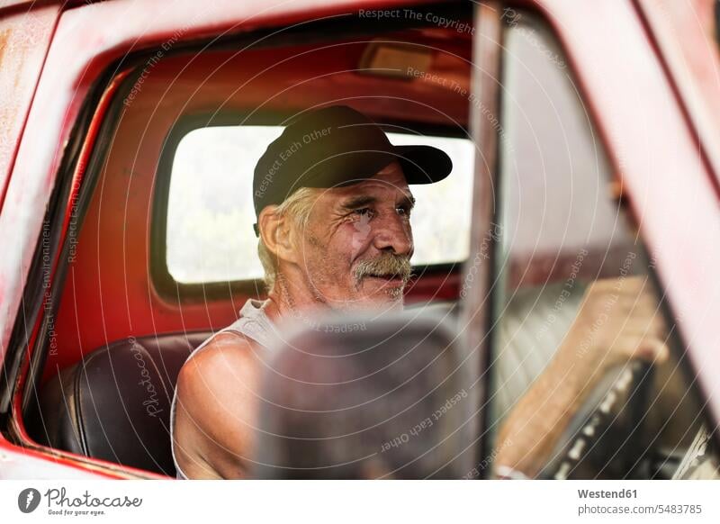 Senior man driving an old pick up Pickup Truck senior men senior man elder man elder men senior citizen drive males Pick Up transport vehicles senior adults