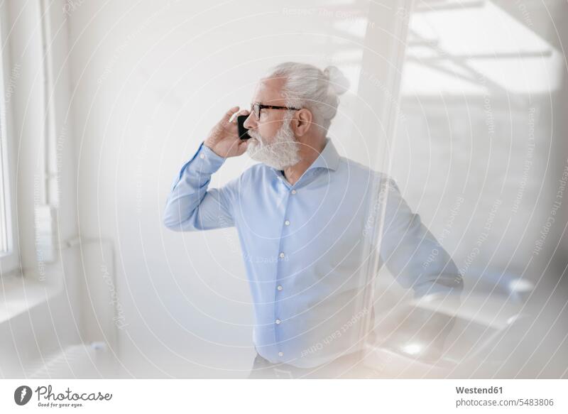 Mature man with beard and glasses on cell phone on the phone call telephoning On The Telephone calling men males mobile phone mobiles mobile phones Cellphone
