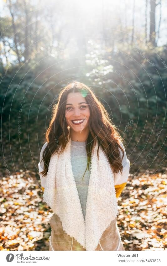 Portrait of a beautiful smiling woman in an autumnal forest fall portrait portraits females women woods forests smile Adults grown-ups grownups adult people