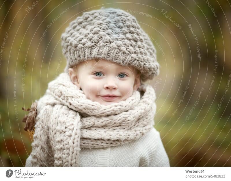 Portrait of happy little girl wearing big scarf and woolly hat in autumn caucasian caucasian ethnicity caucasian appearance european Speyer cool one person 1