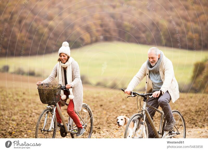 Senior couple doing a bicycle trip with dog senior couple elder couples senior couples riding bicycle riding bike bike riding cycling bicycling pedaling