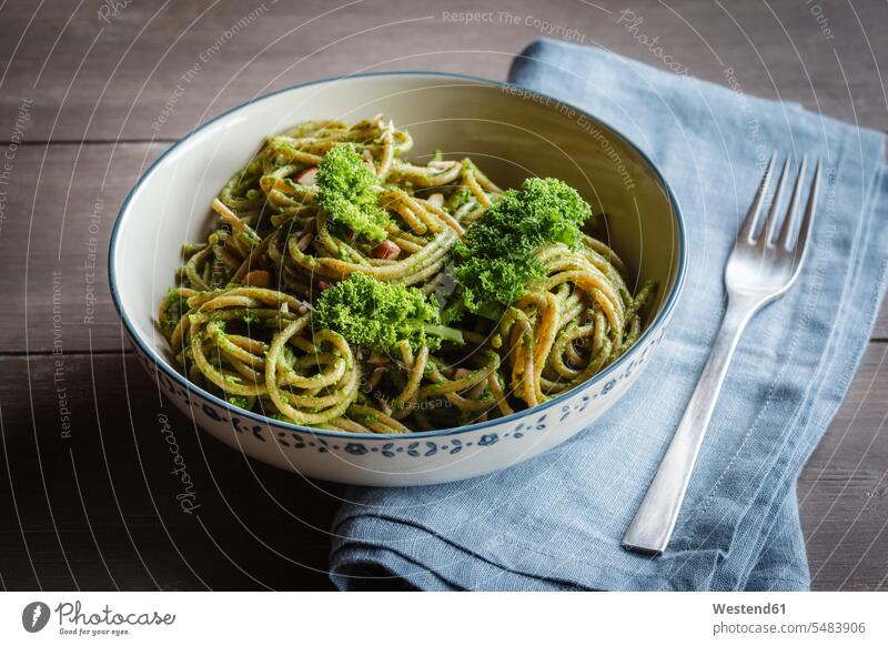 Bowl of whole-grain spelt pasta with kale and hazelnut pesto vegetarian Vegetarian Food nobody green whole-grain noodles close-up close up closeups close ups