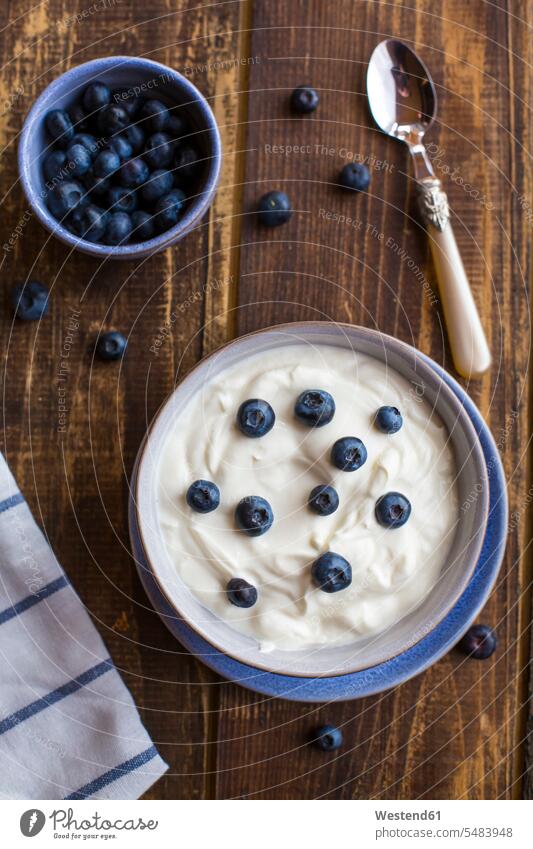 Yogurt with blueberries in bowl on wood food and drink Nutrition Alimentation Food and Drinks Dessert Afters Desserts blueberry bilberry bilberries wooden Bowl