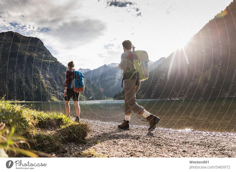 Austria, Tyrol, young couple hiking at mountain lake hike mountain lakes mountains twosomes partnership couples water waters body of water mountainscape
