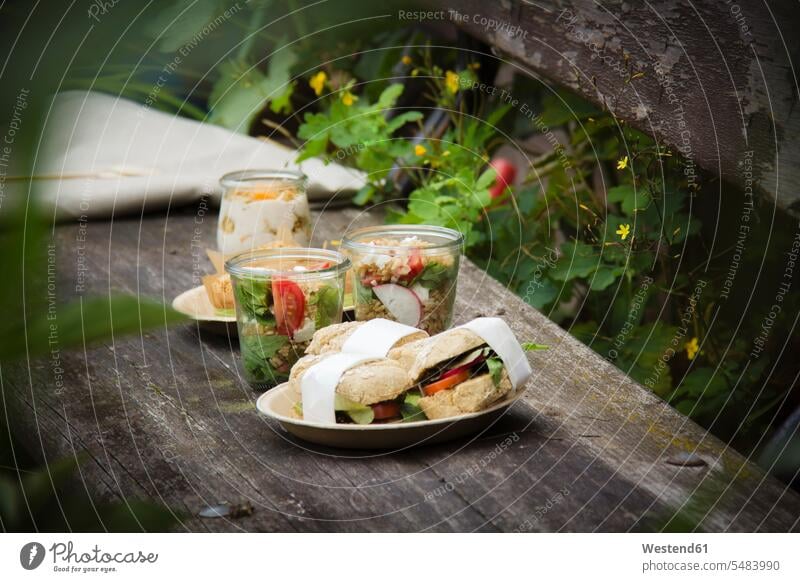 Picnic with vegetarian snacks on bench Snack Snacks Snack Food jar jars wooden bench nature natural world picnicking outdoors outdoor shots location shot