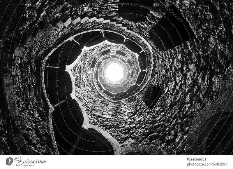 Portugal, Quinta da Regaleira, well shaft with spiral starcaise full frame vanishing point distance spiral staircase worm's eye view extreme worms eye