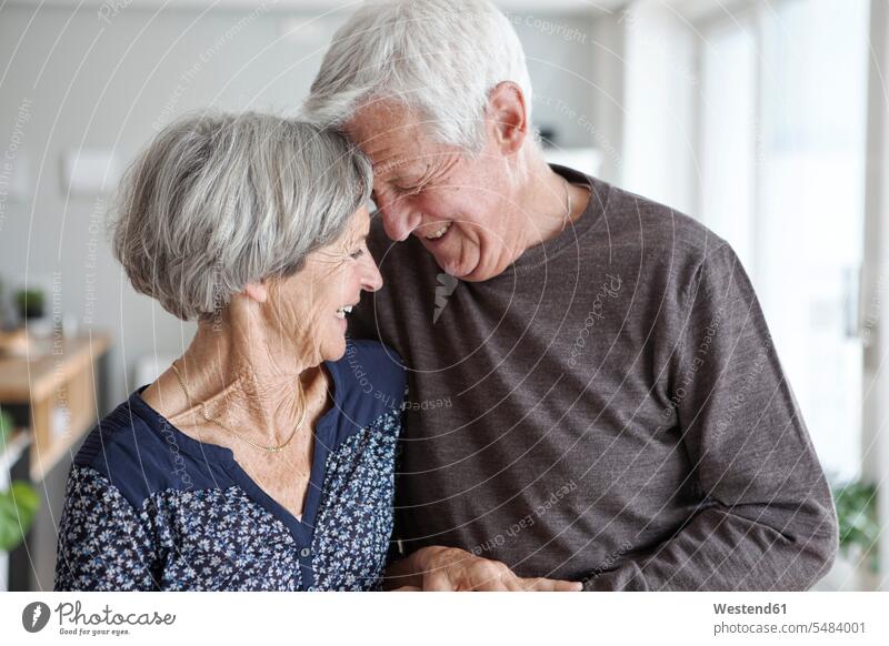 Happy senior couple at home twosome togetherness pensioner pensioners female pensioners waist up Waist-Up upper body upper part shot Lifestyles optimistic