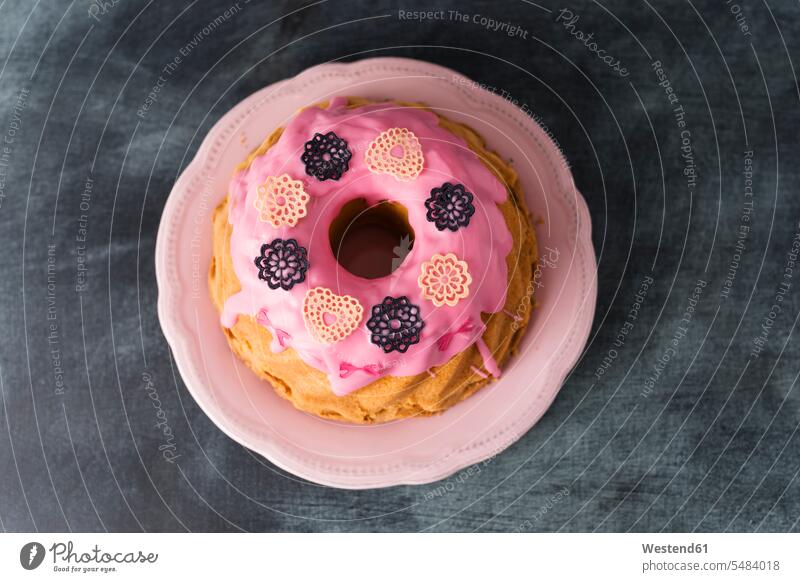 Ring cake with pink icing and baking decor home-baked home-made Birthday cake Birthday cakes sponge-cake sponge cake Rosy decorative decoratively Plate dish