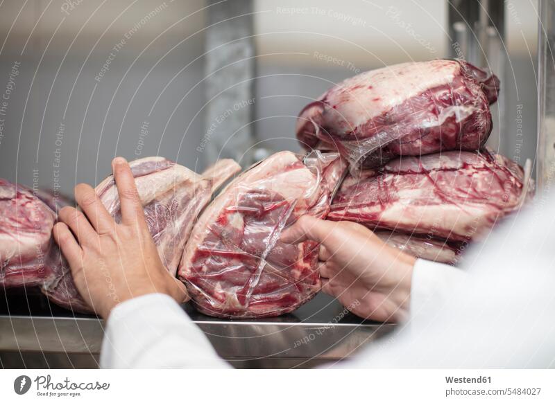 Close-up of butcher packing meat on shelf butchery charcuterie working At Work Food foods food and drink Nutrition Alimentation Food and Drinks sealed wrapped