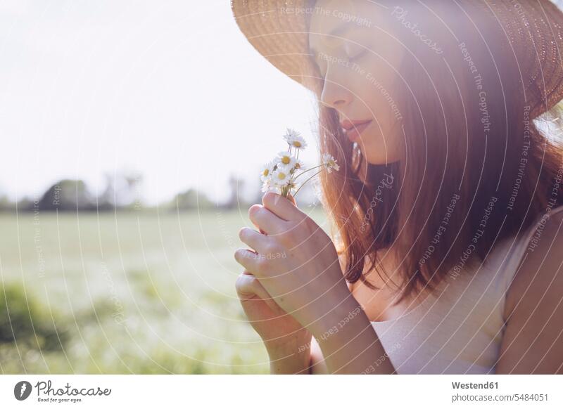 Young woman with daisies at backlight Tuscany beauty beautiful tranquility tranquillity Calmness Sensory Perception copy space focus on foreground