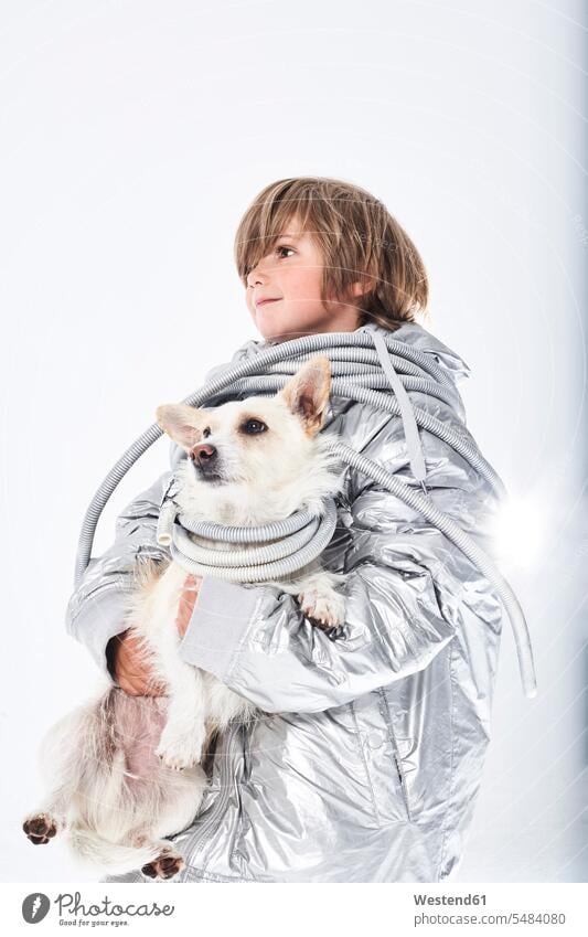 Boy wearing fancy dress carrying dog boy boys males fancy-dress costume Fancy Dress Costumes disguise costumes holding playing dogs Canine child children kid