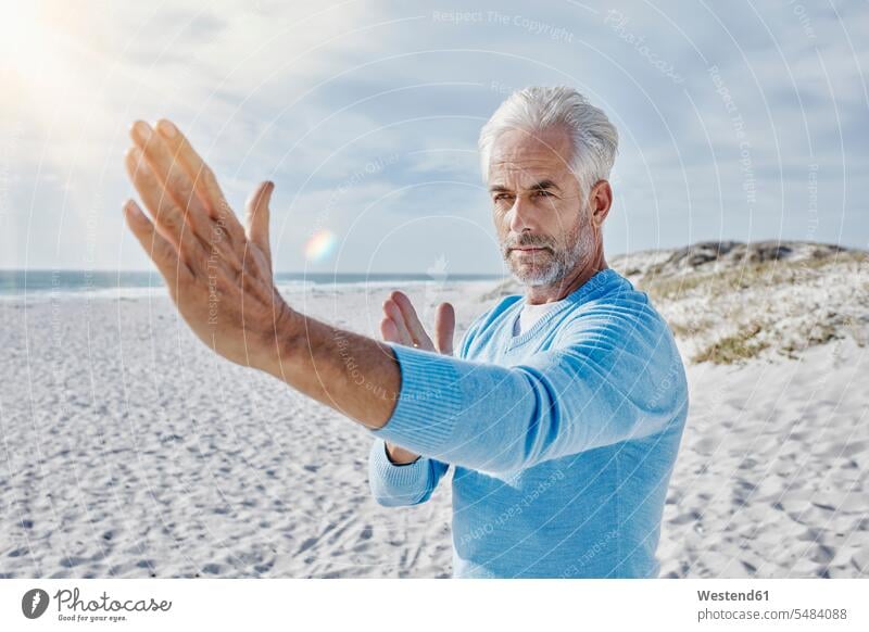 Portrait of man practising Tai Chi on the beach men males Tai chi Taijiquan Adults grown-ups grownups adult people persons human being humans human beings sport