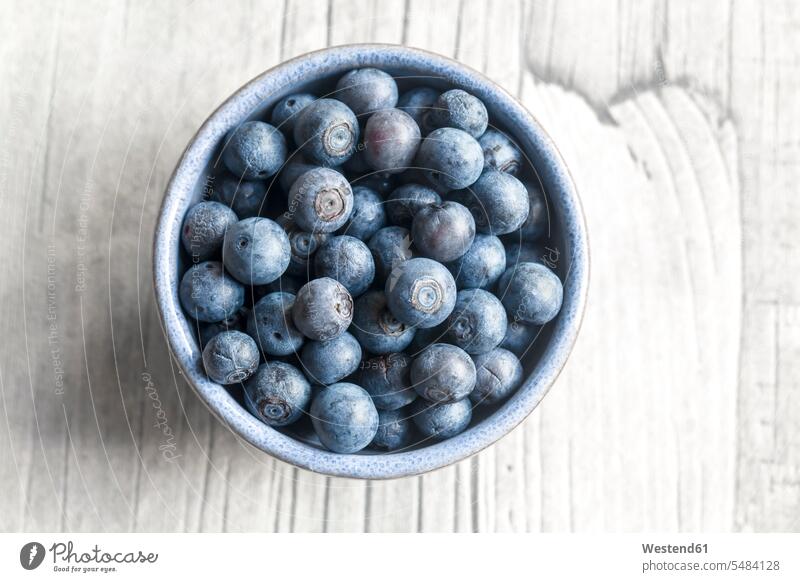 Bowl of blueberries on wood food and drink Nutrition Alimentation Food and Drinks cup Bowls close-up close up closeups close ups close-ups wooden blueberry