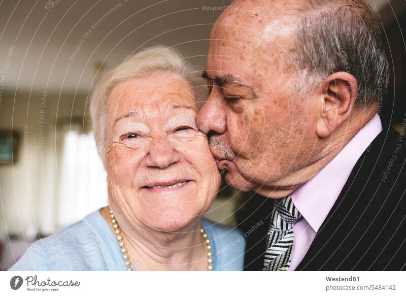 Senior man kissing his happy wife caucasian caucasian ethnicity caucasian appearance european heterosexual couple straight couple heterosexual couples