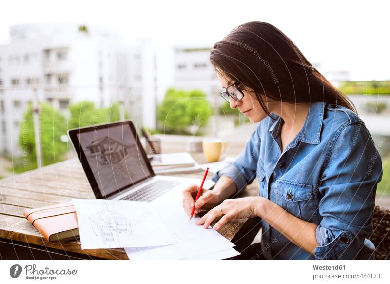 Architect working on balcony at home home office working from home home business working at home Work From Home writing down noting balconies At Work woman